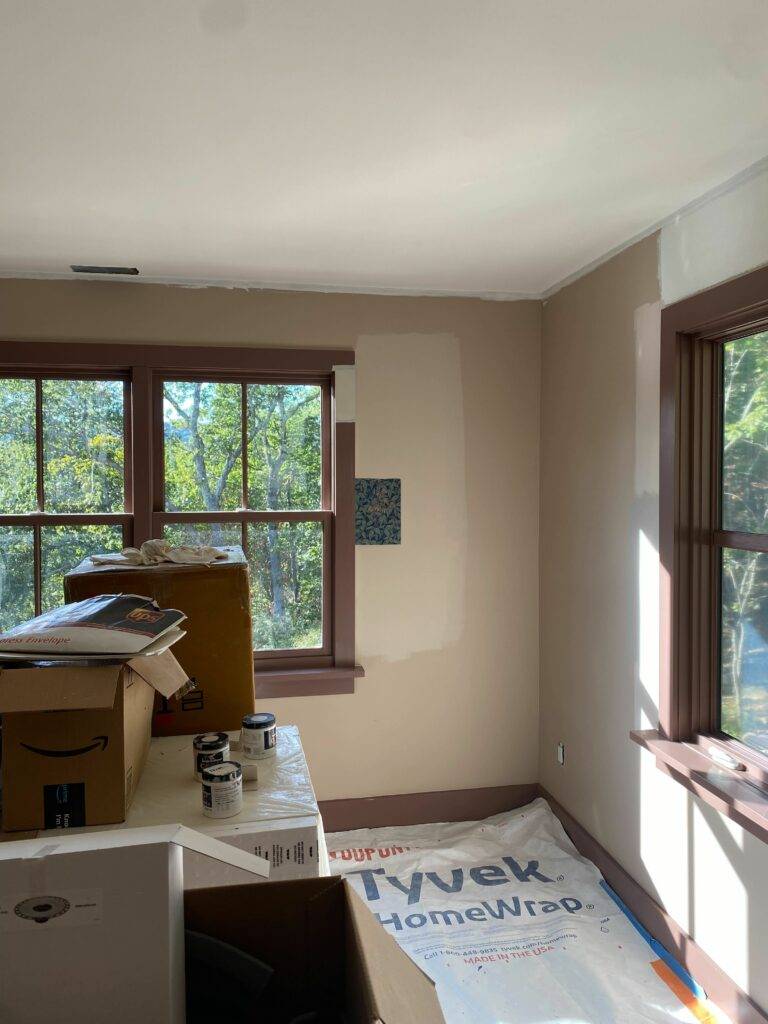 Large primary window painted with "hot chocolate" trim and "band aid" walls.